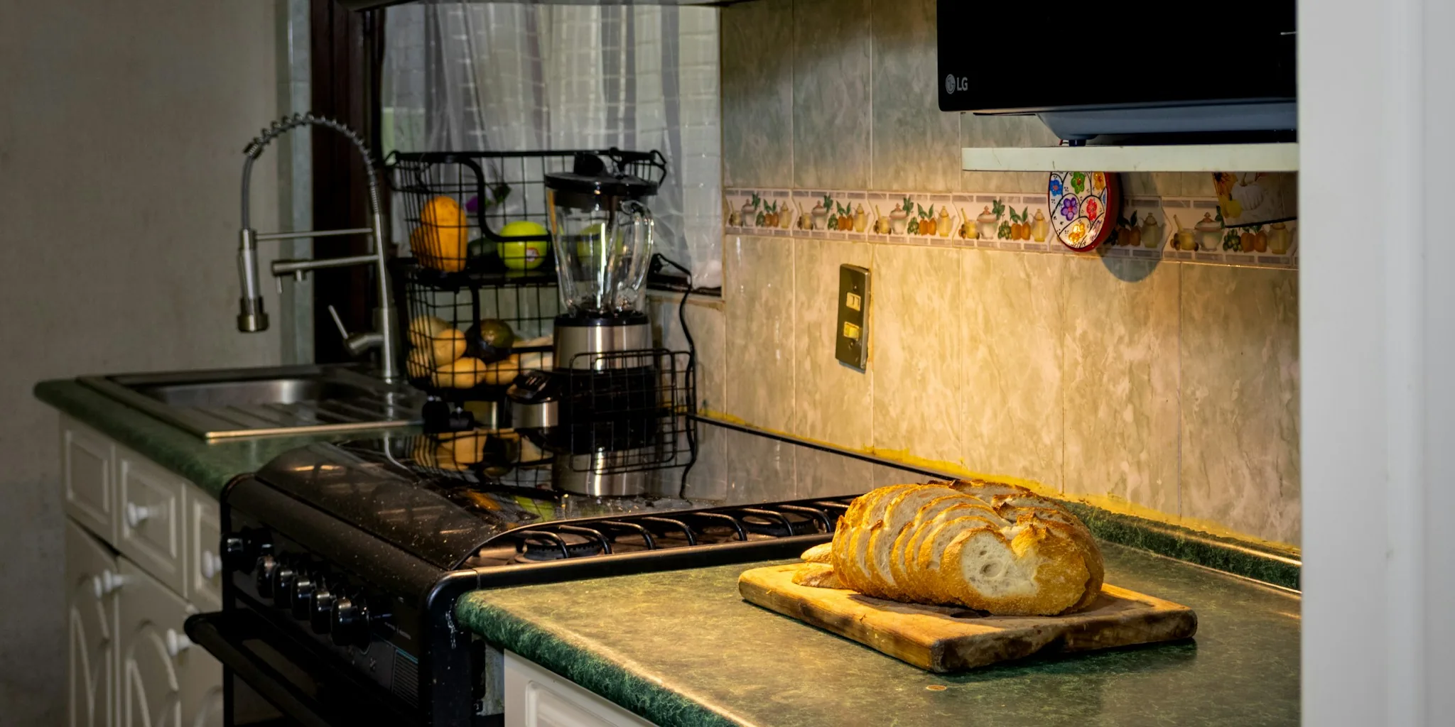 Air fryer with open basket on kitchen counter displaying food cooking