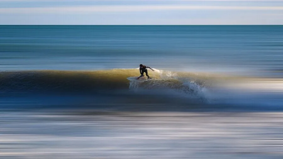 Athlete capturing high-speed action during outdoor sports activity with motion blur effect