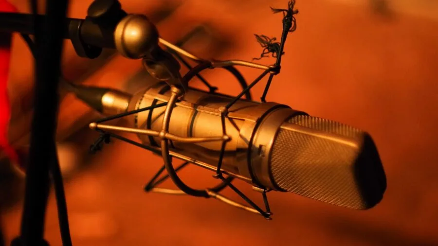 Content creator recording audio with microphone during outdoor interview session