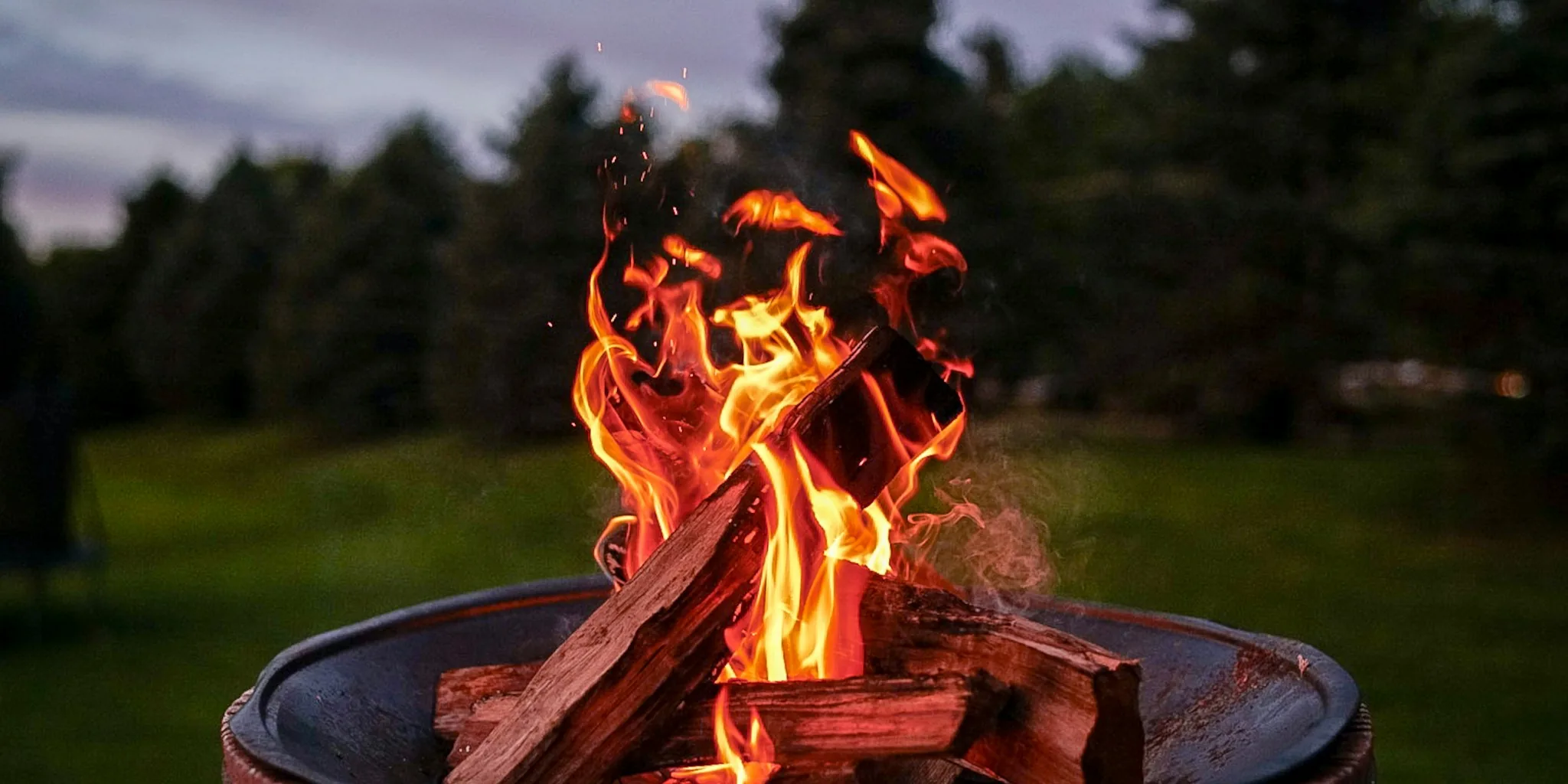 Fire pit with flames in outdoor backyard setting