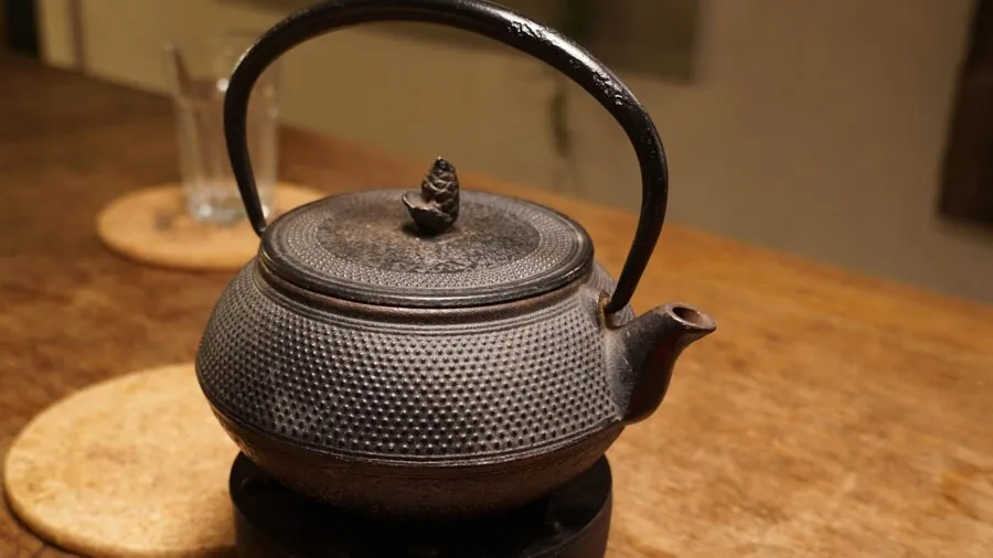 Home cook preparing meal in rustic kitchen with well-used cast iron skillet on stovetop