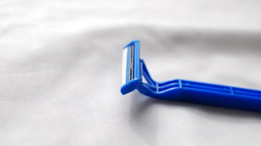Man holding electric shaver with comfortable grip during morning grooming routine in bathroom
