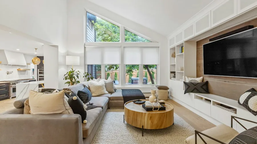 Modern living room with smart home devices and controls on display, showing connected home automation setup