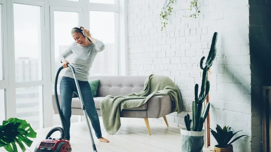 Person breathing fresh air by bright window in clean modern living room