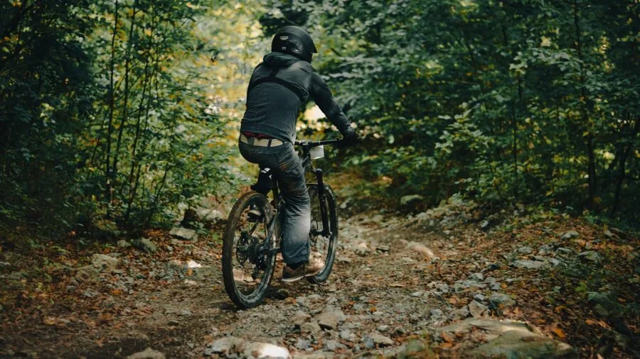Person comfortably cycling on a scenic path wearing padded cycling shorts
