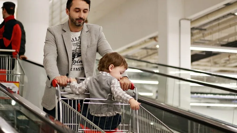 Person reviewing and comparing different product options while shopping, evaluating value and price points